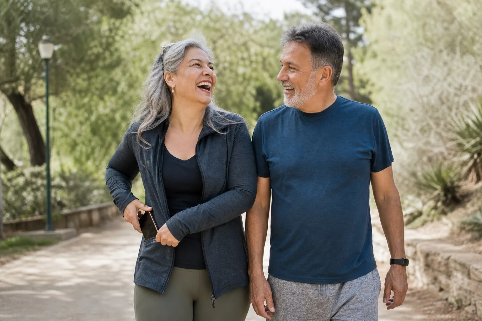 A couple walking together in a park.